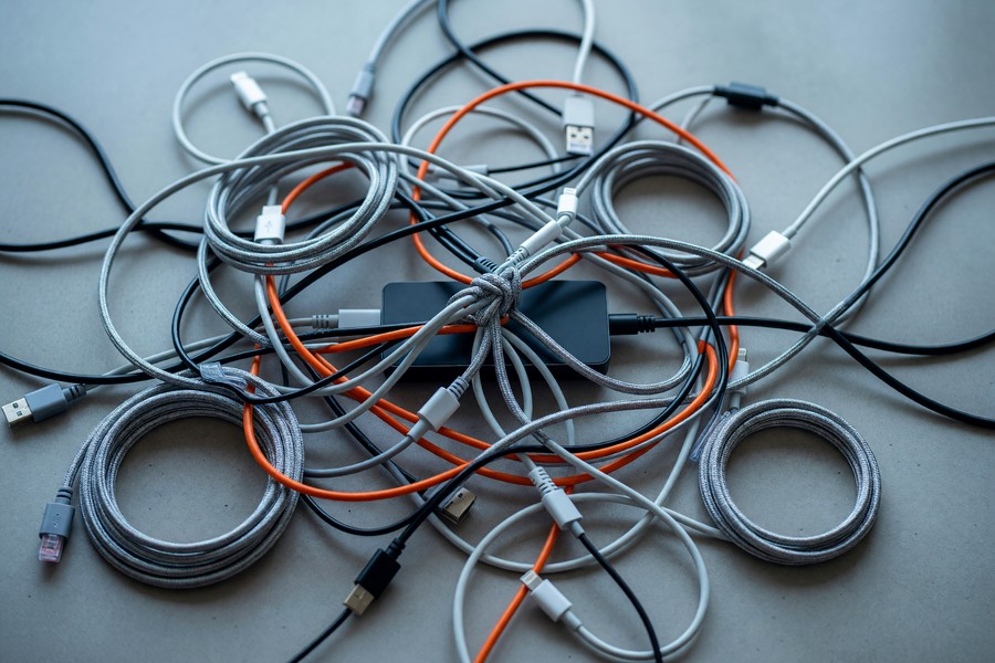 Smartphone showing a unified smart home app dashboard controlling lights, locks, and thermostat