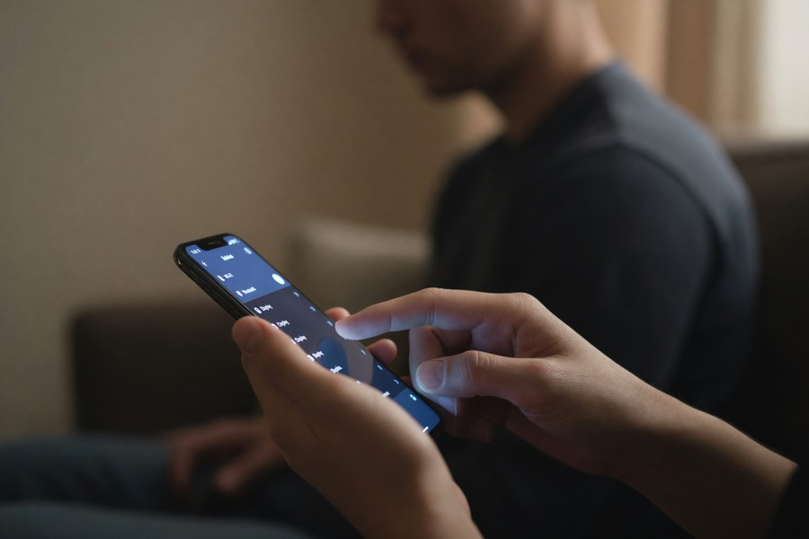 Smartphone screen showing unusual app permissions with a warning alert overlay