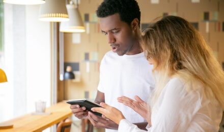 Therapist reviewing messaging app policy on tablet with HIPAA-compliant communication guidelines displayed