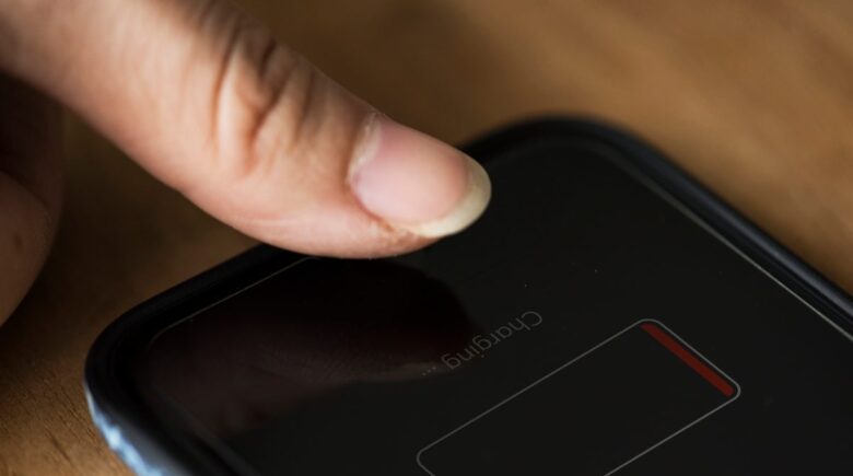 iPhone 14 Pro displaying dark mode interface with battery percentage indicator visible