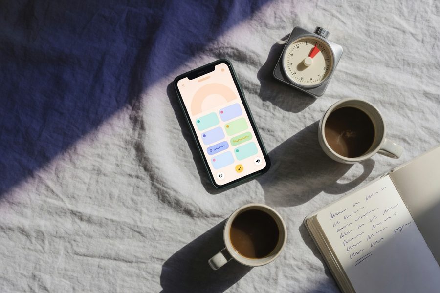 Person pausing language app mid-lesson while multitasking at home