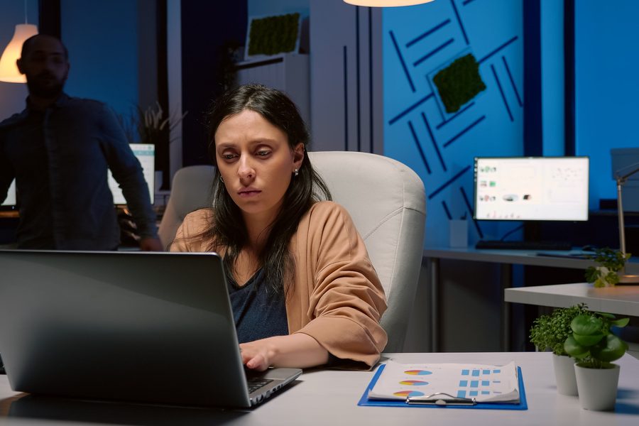 Accountant reviewing a phishing email alert on a laptop with visible concern
