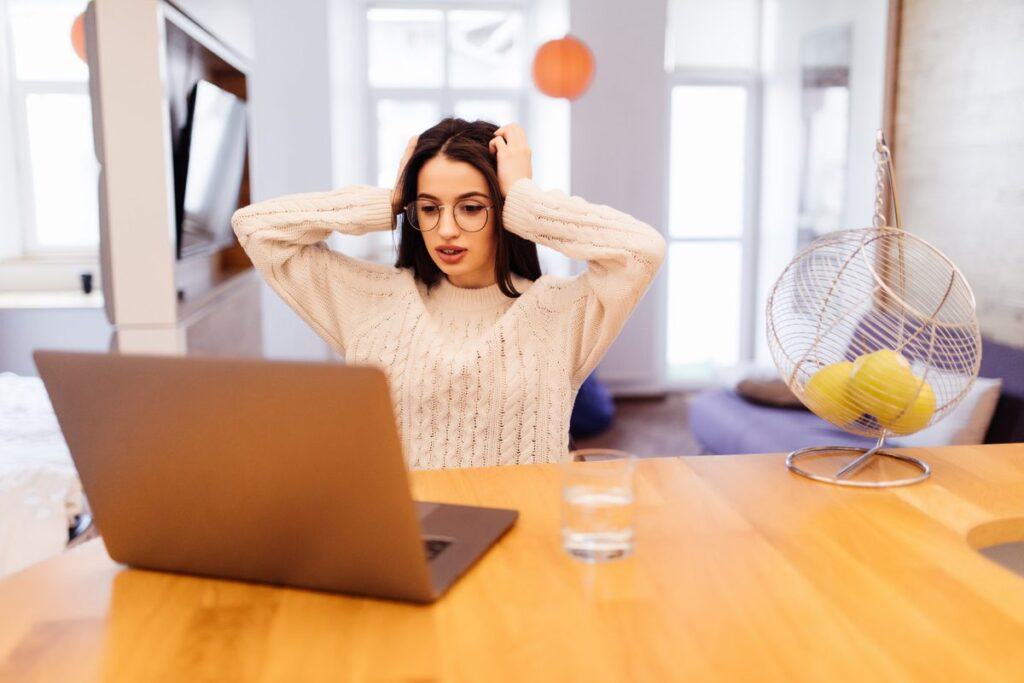 Remote worker looking at phone with group messaging notifications on screen