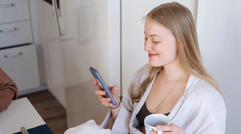 Phone screen showing a messaging app reminder notification for evening wind-down routine with dimmed lighting in background