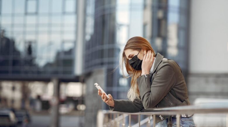 Person in bed at night looking at phone screen, showing stress and sleep disruption from late-night texting