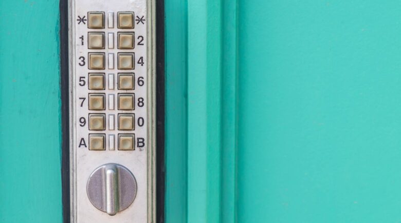 Person holding smartphone up to a smart door lock to unlock it with NFC technology