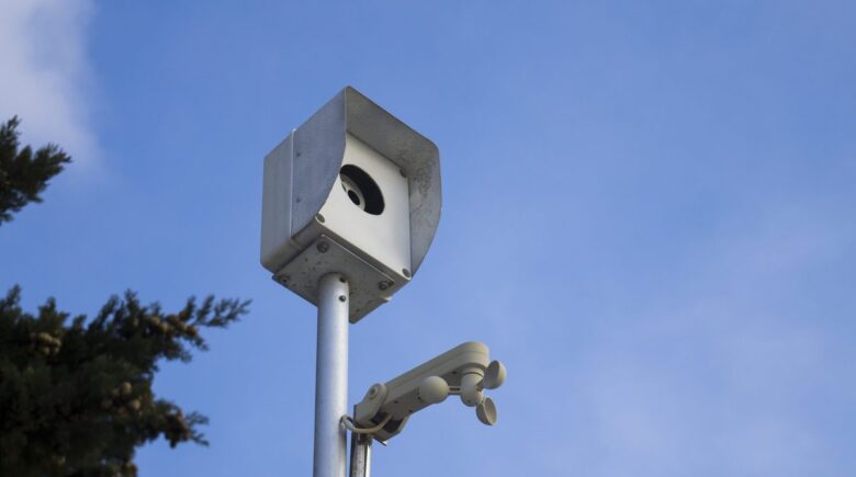 Smartphone mounted on stand functioning as a security camera with motion detection enabled