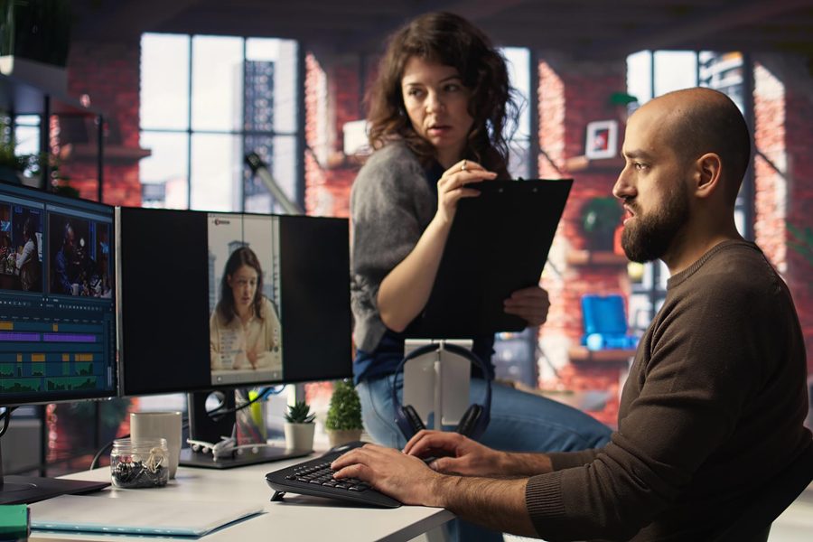 Freelancer juggling multiple chat workspaces with visible stress