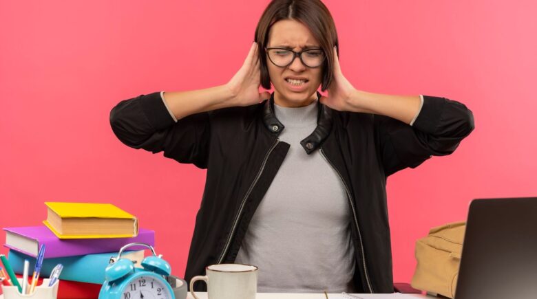 Person at desk with phone in drawer, calm expression, peaceful workspace